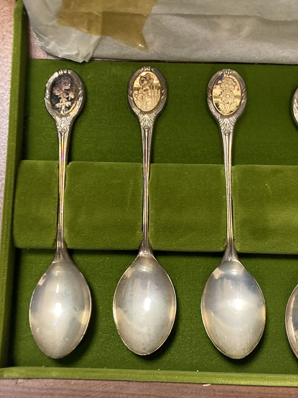 A modern cased set of twelve parcel gilt silver Royal Horticultural Society Flower Spoons by John Pinches,